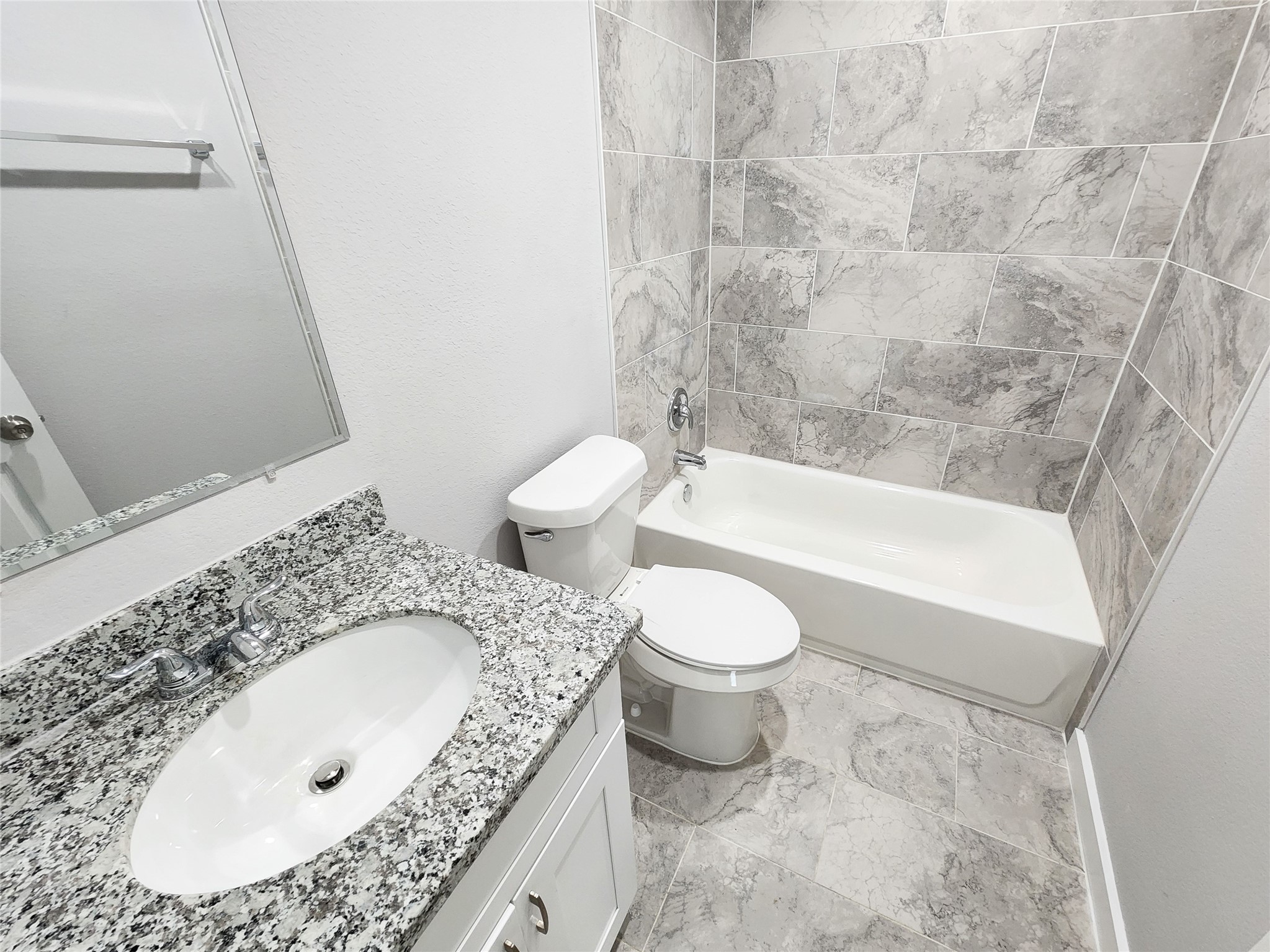 7735 Orebo Street, Unit B Houston, TX 77088 - Photo 6 of 14 a bathroom with a granite countertop sink a toilet and bathtub