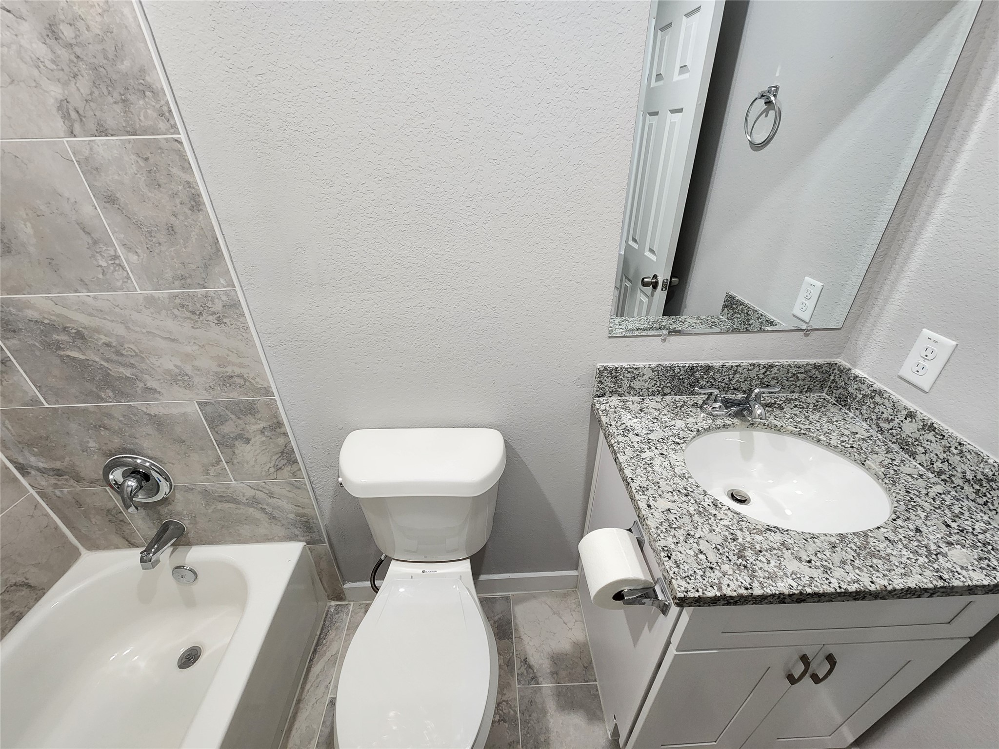 7735 Orebo Street, Unit B Houston, TX 77088 - Photo 9 of 14 a bathroom with a granite countertop sink and a mirror