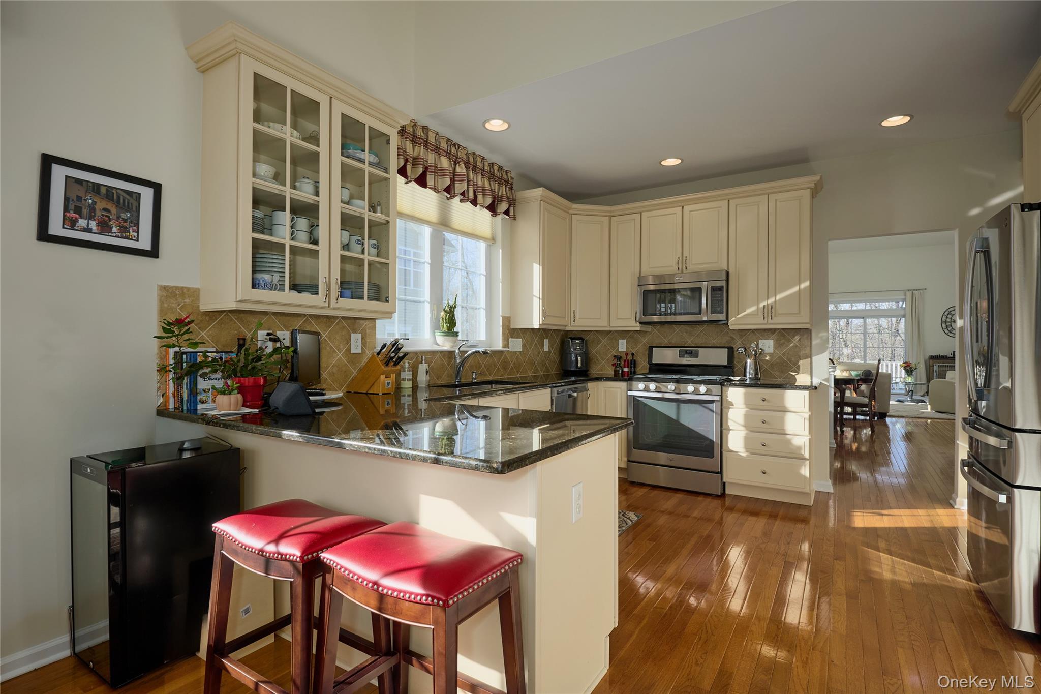 40 Evan Court Fishkill, NY 12508 - Photo 15 of 49 a kitchen with stainless steel appliances granite countertop a stove top oven a sink dishwasher and cabinets with wooden floor