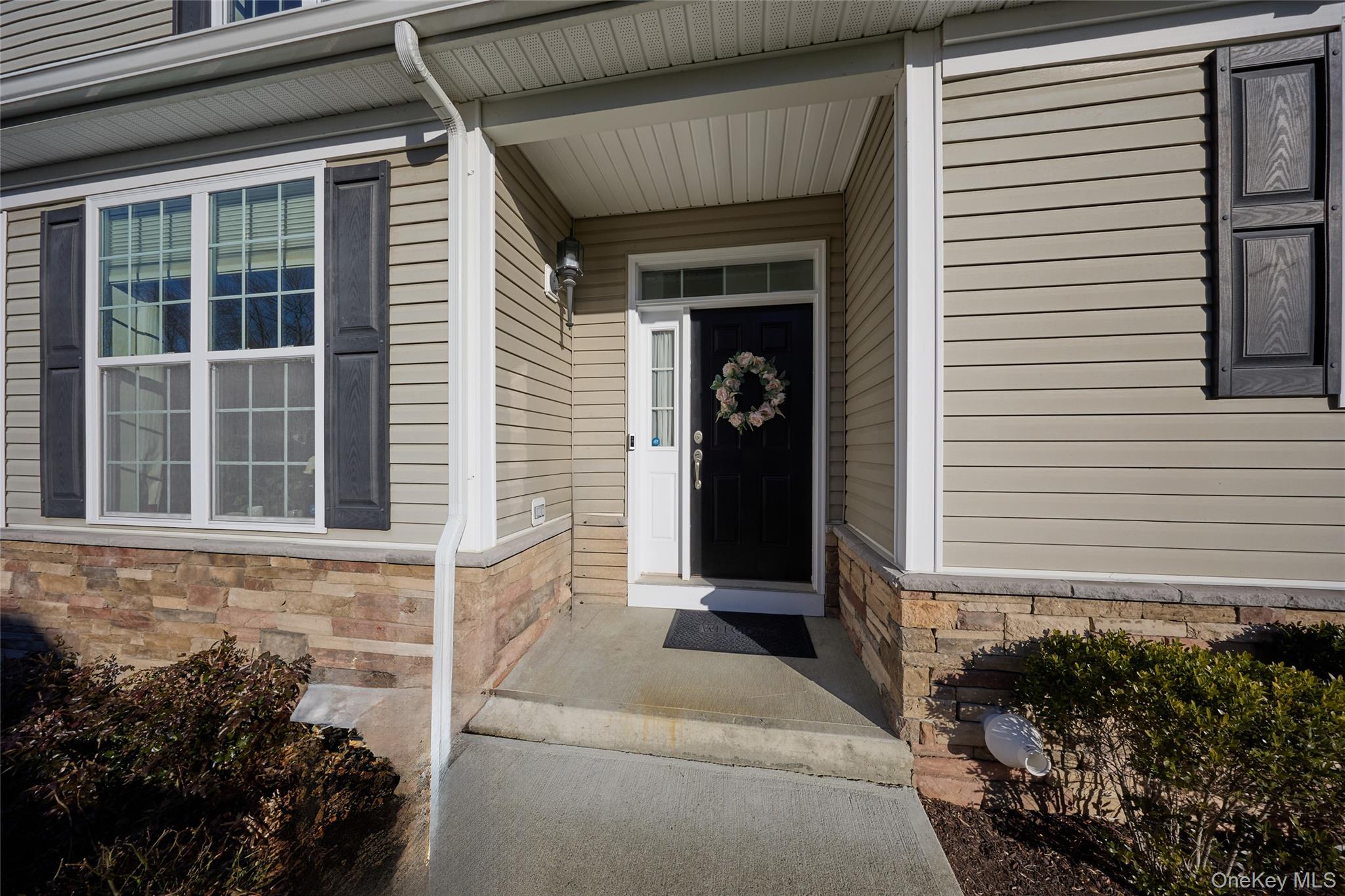 40 Evan Court Fishkill, NY 12508 - Photo 3 of 49 a front view of a house with a yard and potted plants