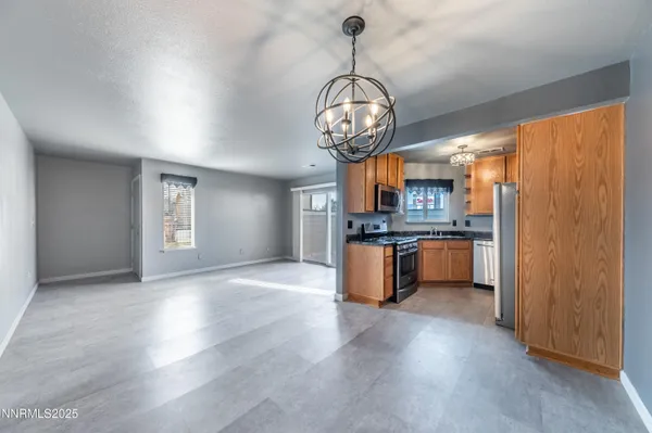 a view of a kitchen with a sink stainless steel appliances and cabinets