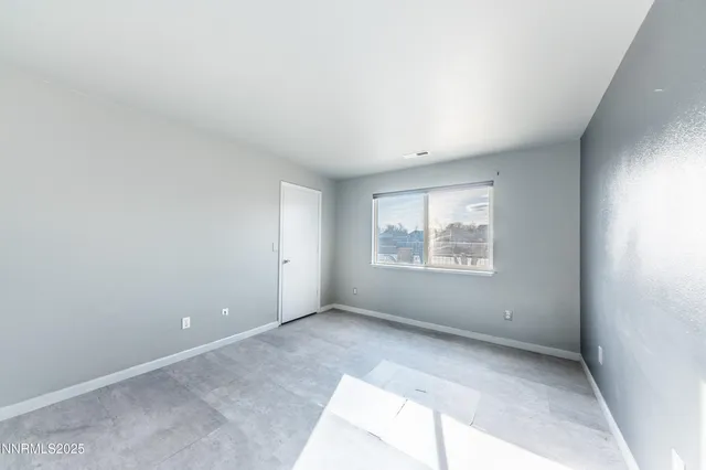 a bathroom with a sink vanity granite toilet and a mirror