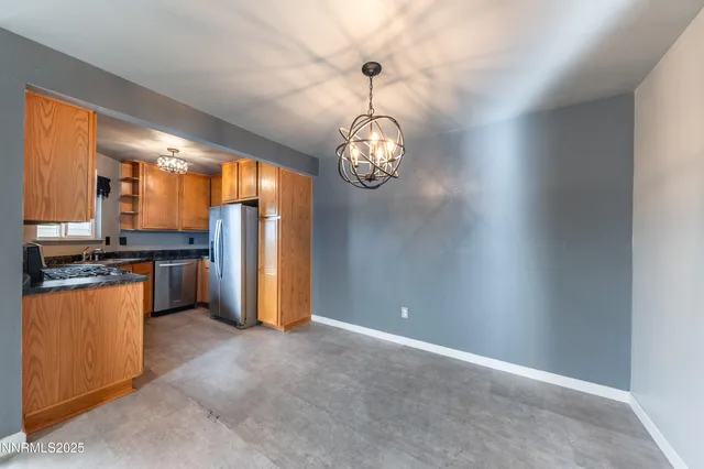 a view of a kitchen with a refrigerator a stove top oven and a refrigerator