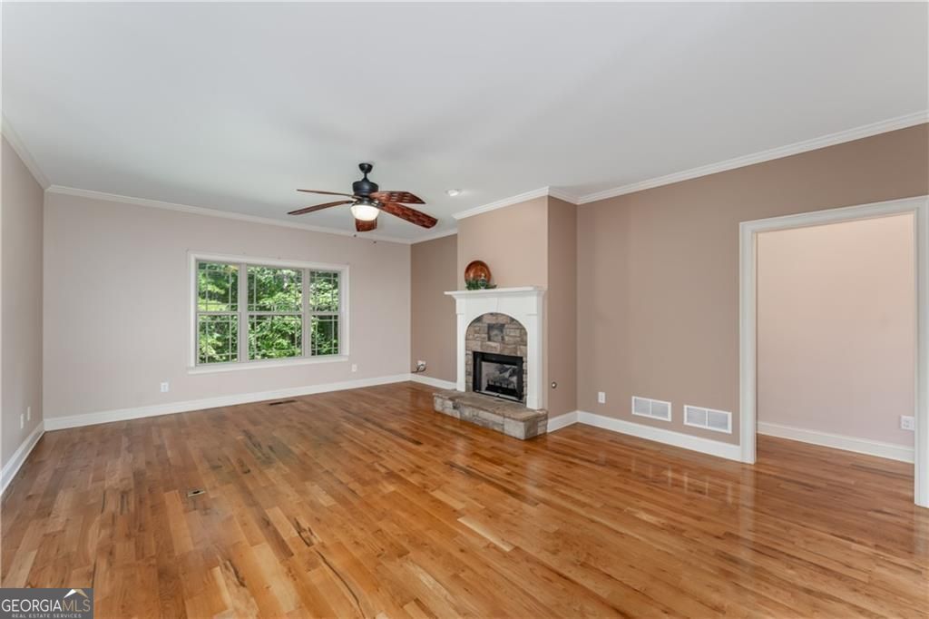 1158 Bailey Road Aragon, GA 30104 - Photo 4 of 73 a view of a livingroom with wooden floor a ceiling fan and a window
