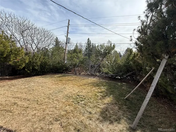 a view of deck with chairs and wooden fence