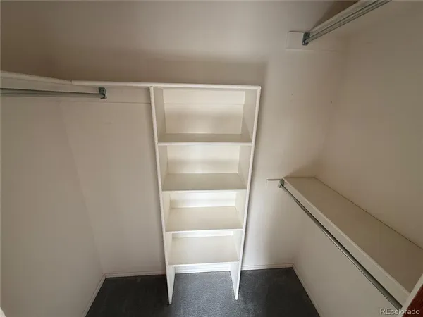 a bathroom with a granite countertop sink a mirror and a shower