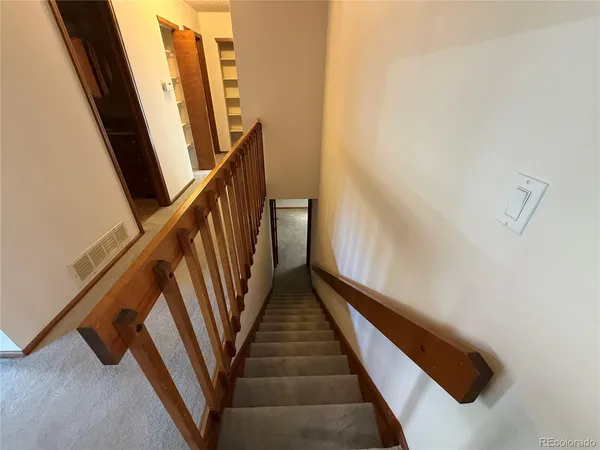 an empty room with windows and cabinet