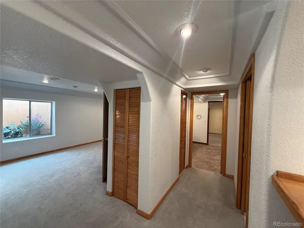 a bathroom with a granite countertop sink a toilet a mirror and vanity