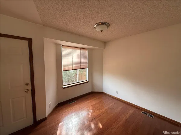 a living room with stainless steel appliances kitchen island granite countertop furniture a refrigerator and a sink