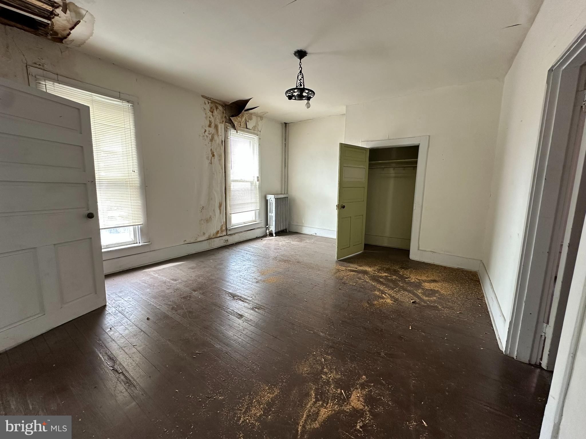 513-515 Penn Street Huntingdon, PA 16652 - Photo 11 of 23 an empty room with wooden floor and windows