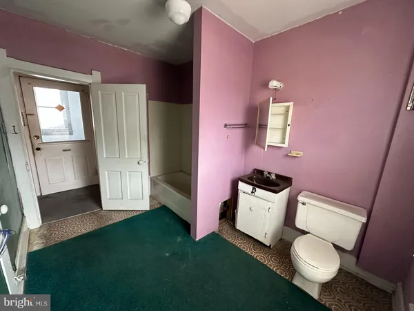 a bathroom with a sink toilet and mirror