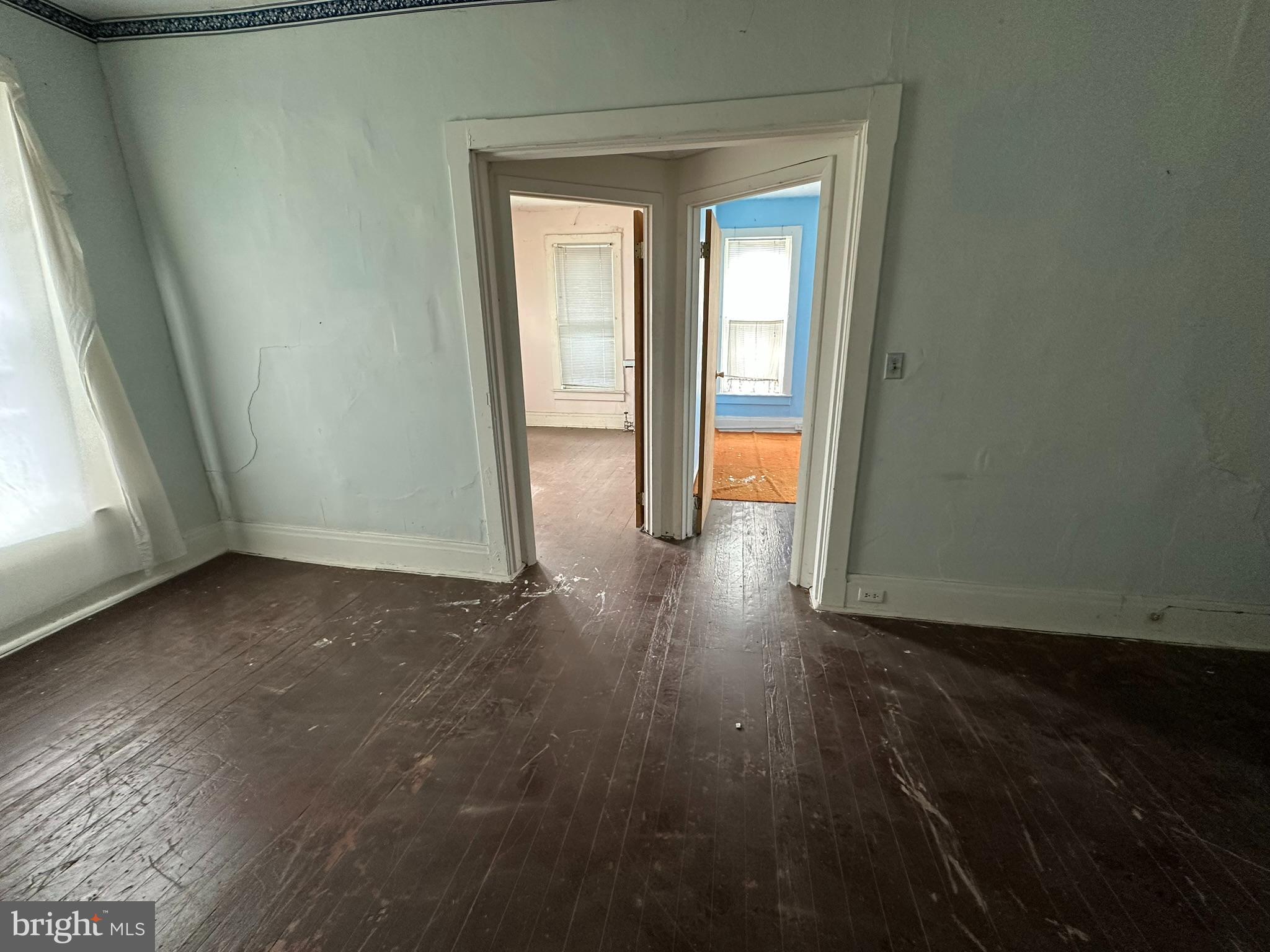 513-515 Penn Street Huntingdon, PA 16652 - Photo 10 of 23 a view of an empty room with wooden floor and a window