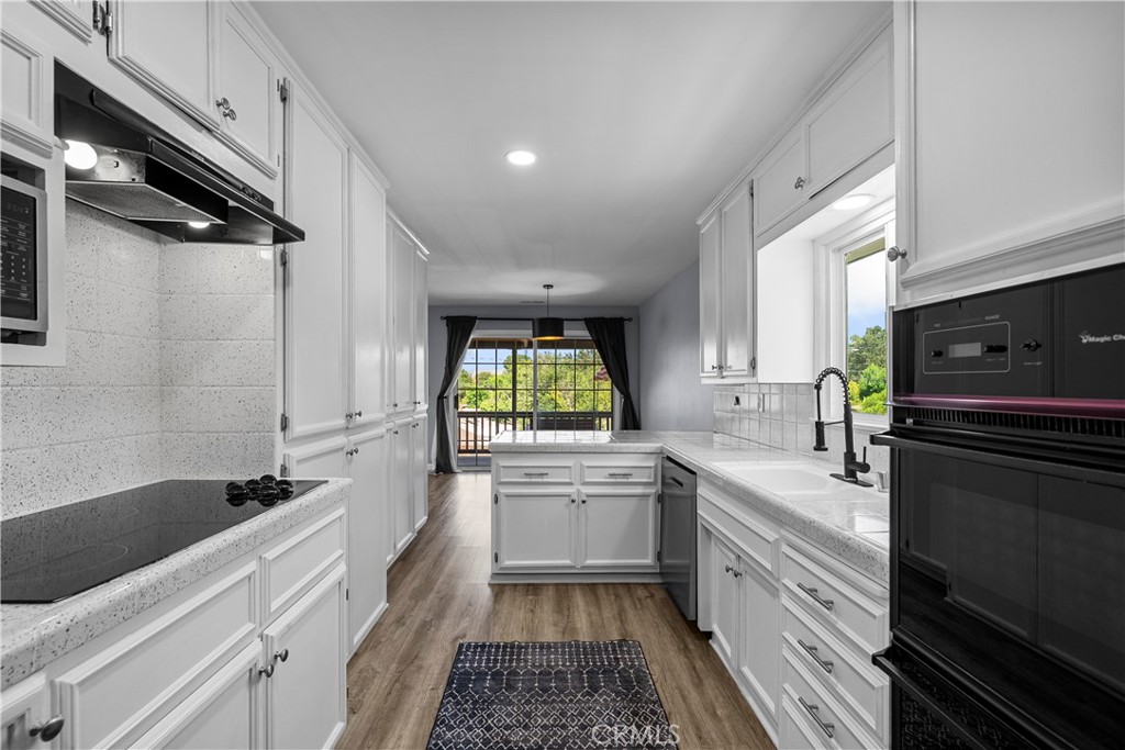 25083 Wheeler Road Newhall, CA 91321 - Photo 14 of 46 a kitchen with a sink stove and refrigerator
