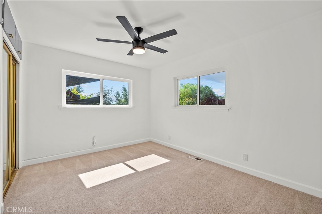 25083 Wheeler Road Newhall, CA 91321 - Photo 29 of 46 an empty room with a window and a fan