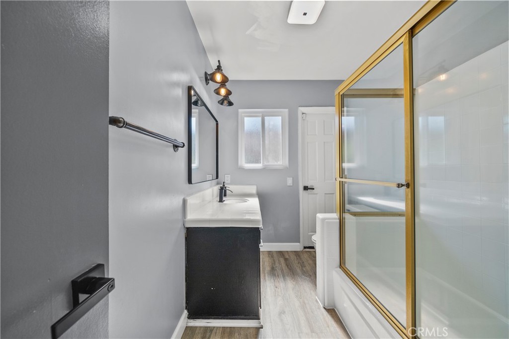 25083 Wheeler Road Newhall, CA 91321 - Photo 30 of 46 a bathroom with a double vanity sink a mirror and a shower