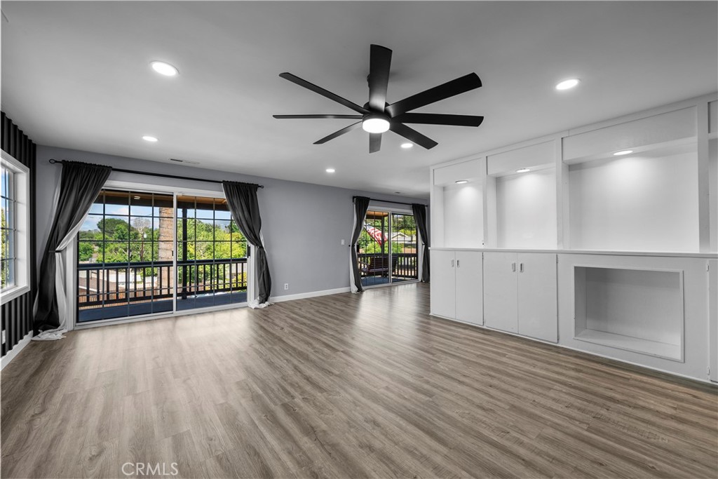 25083 Wheeler Road Newhall, CA 91321 - Photo 6 of 46 an empty room with wooden floor and windows