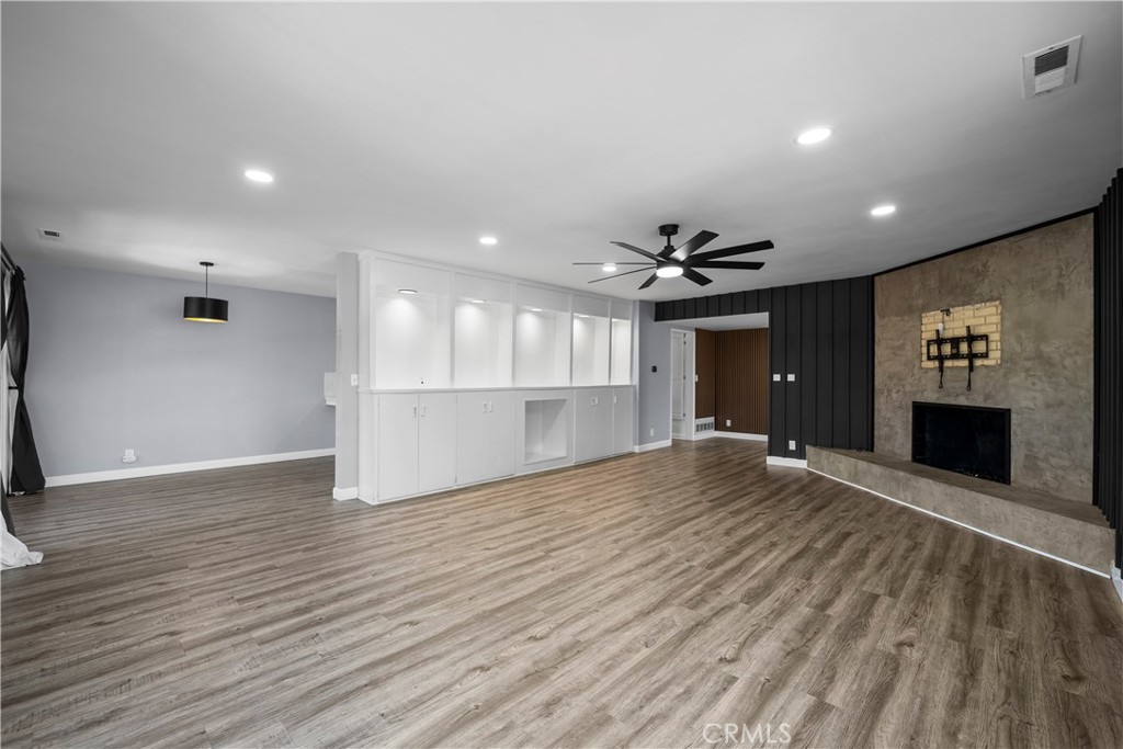 25083 Wheeler Road Newhall, CA 91321 - Photo 7 of 46 an empty room with wooden floor fireplace and windows