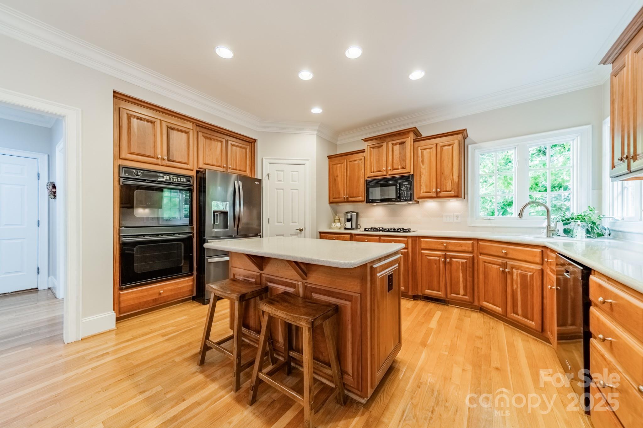 4646 Eagle Pointe Court Denver, NC 28037 - Photo 13 of 47 a kitchen with stainless steel appliances granite countertop wooden cabinets a sink a stove a dining table and chairs