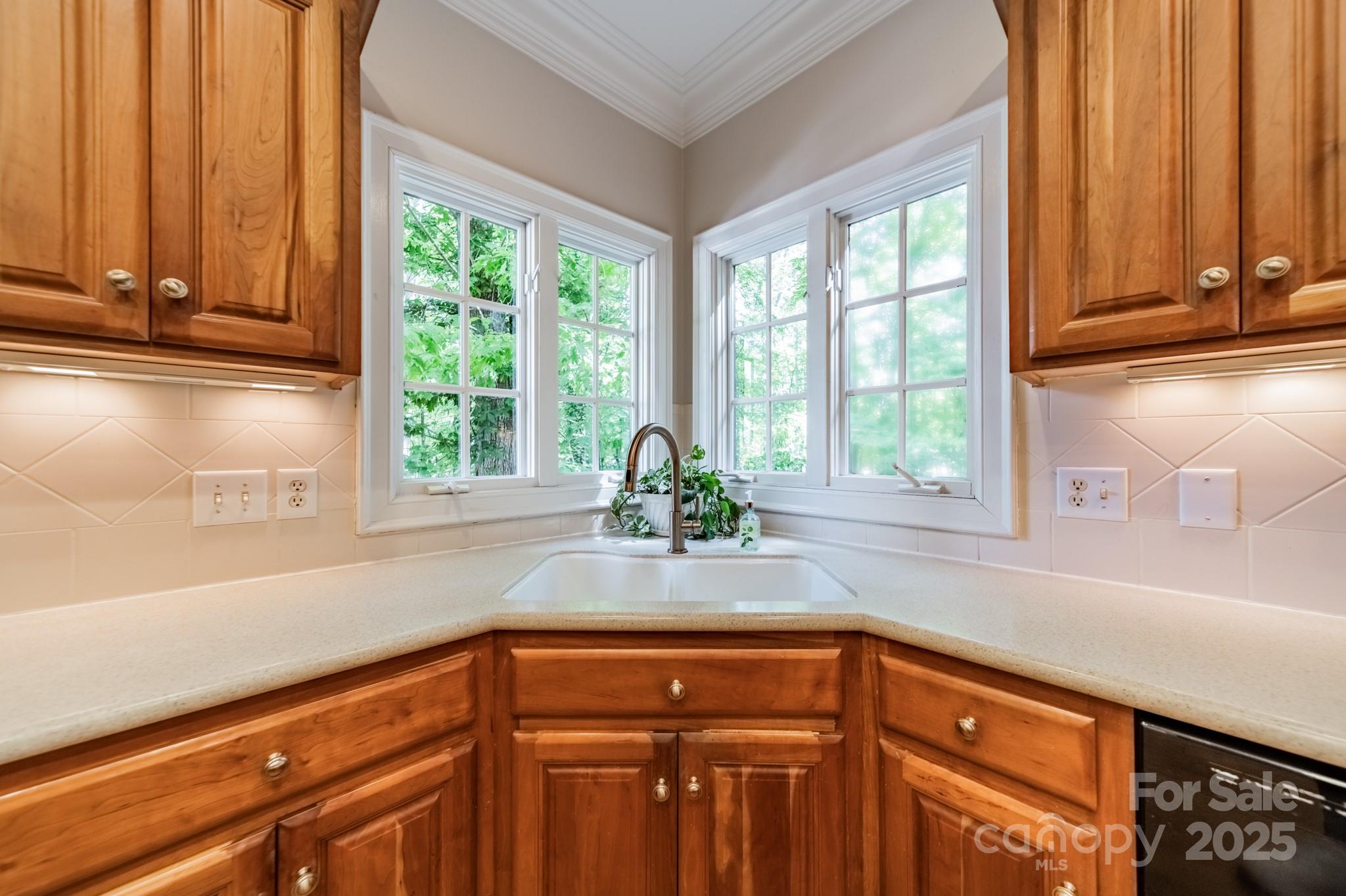 4646 Eagle Pointe Court Denver, NC 28037 - Photo 15 of 47 a kitchen with stainless steel appliances wooden cabinets a sink and a large window