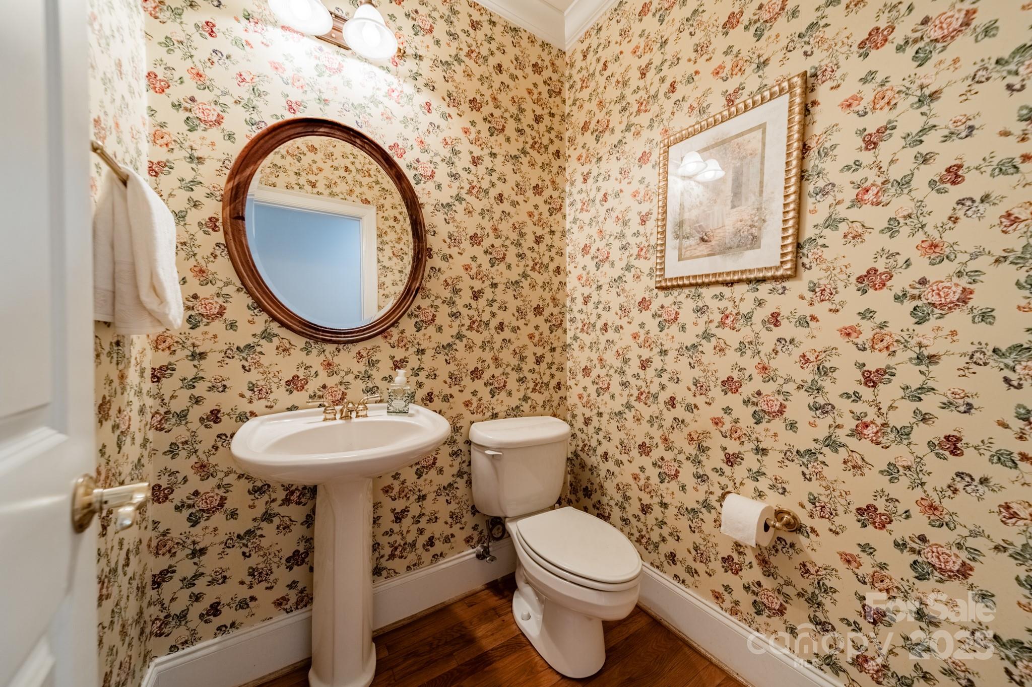 4646 Eagle Pointe Court Denver, NC 28037 - Photo 22 of 47 a bathroom with a toilet sink and mirror