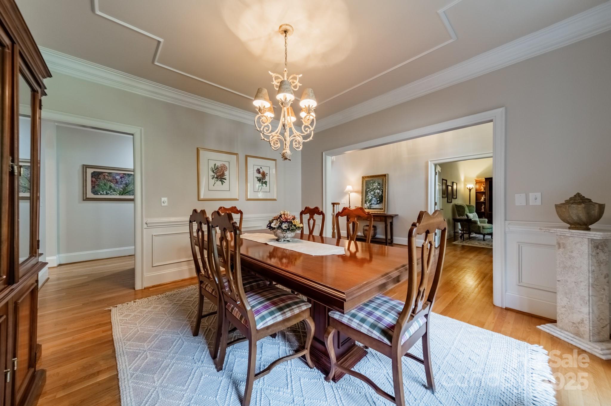 4646 Eagle Pointe Court Denver, NC 28037 - Photo 7 of 47 a dining room with furniture a chandelier and wooden floor