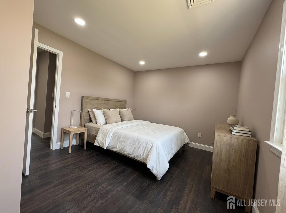 53 North Post Road West Windsor, NJ 08550 - Photo 24 of 36 a bedroom with a bed and wooden floor