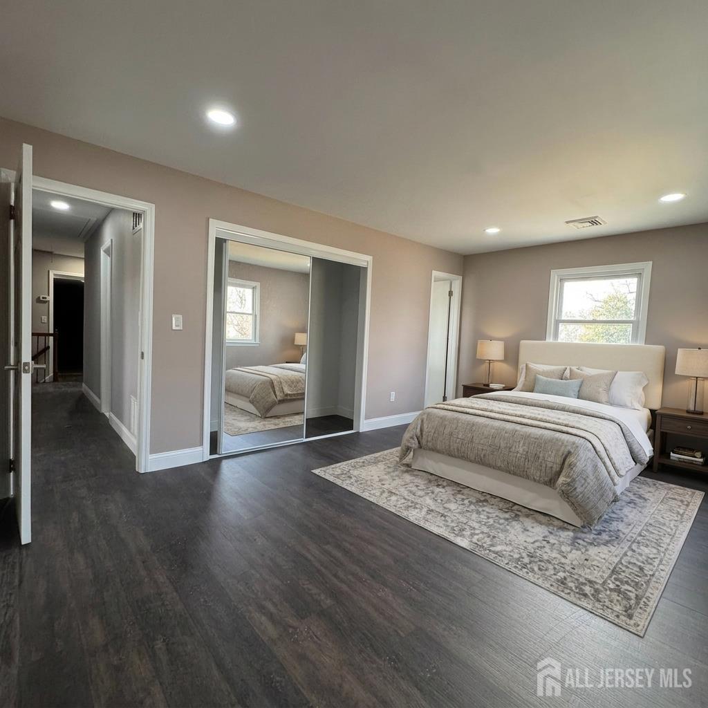 53 North Post Road West Windsor, NJ 08550 - Photo 28 of 36 a spacious bedroom with a bed and wooden floor