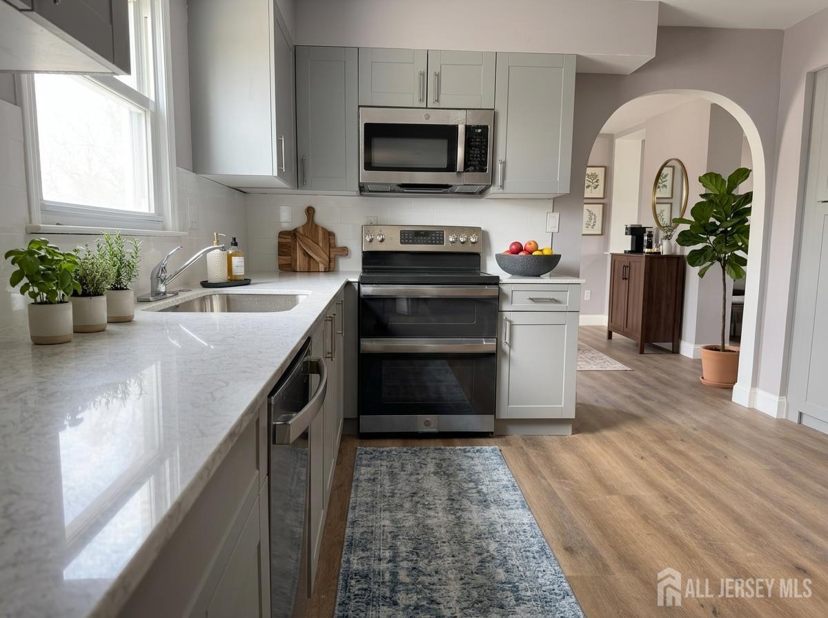 53 North Post Road West Windsor, NJ 08550 - Photo 5 of 36 a kitchen with stainless steel appliances granite countertop a stove a sink and a microwave