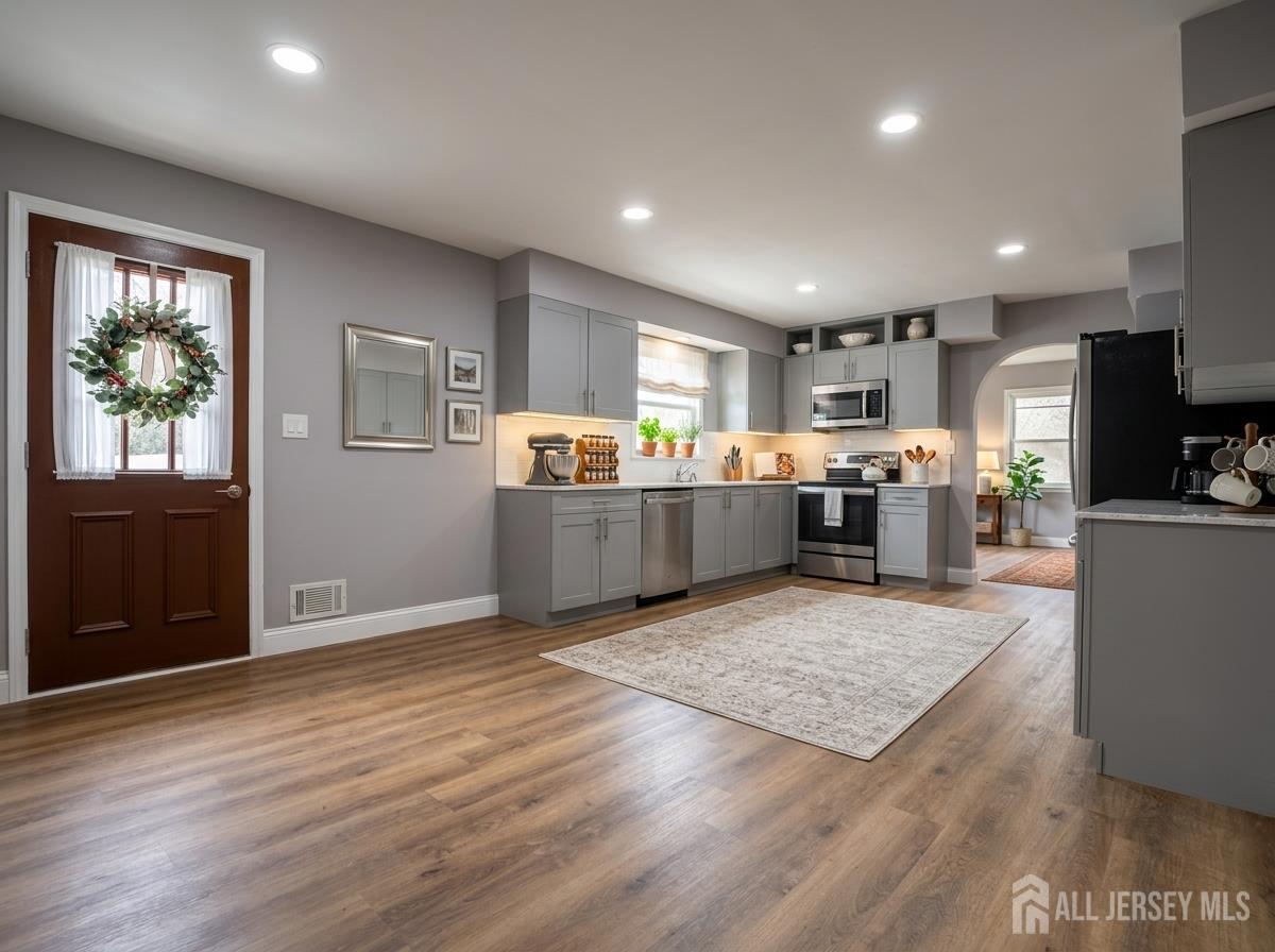 53 North Post Road West Windsor, NJ 08550 - Photo 7 of 36 a view of kitchen with wooden floor and electronic appliances