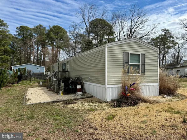 a view of a house with a yard and a tree