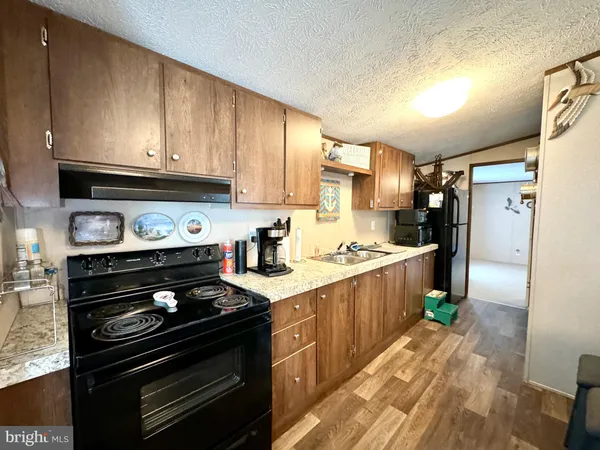 a kitchen with a stove a sink and a refrigerator