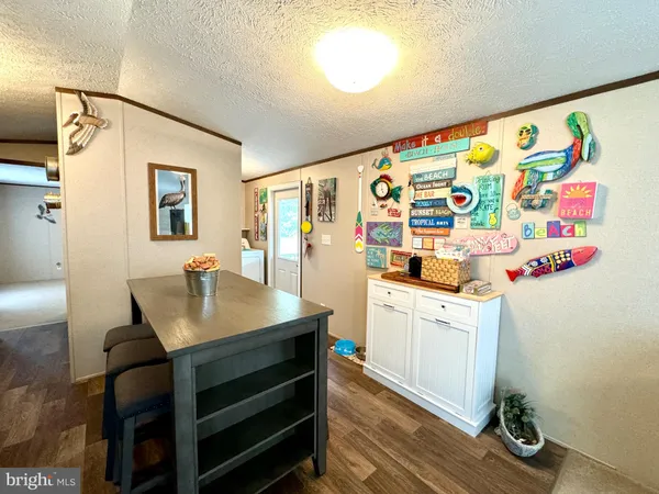a kitchen with granite countertop a sink a stove and a wooden cabinets