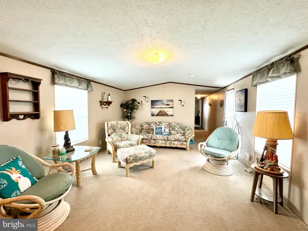 a bedroom with a bed window and couch