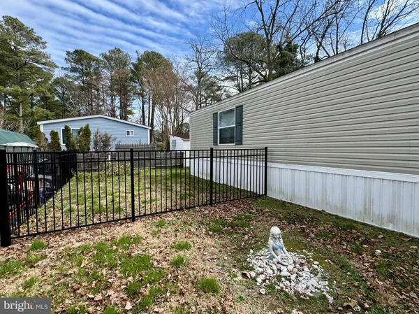 a view of a backyard with a fence