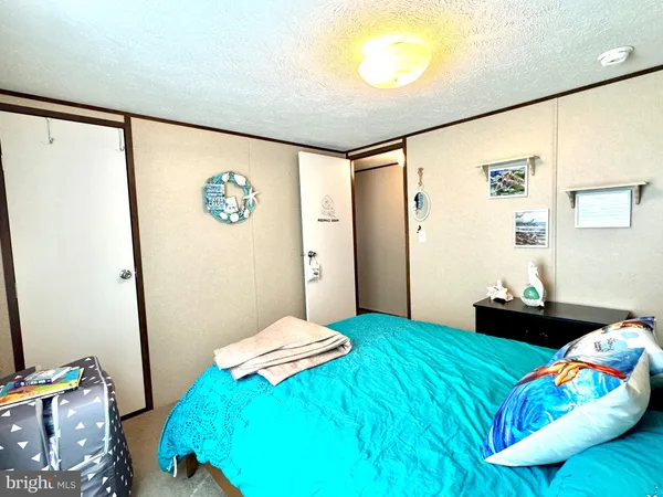 a bed room with a bed mirror and a window