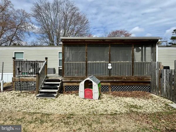 a view of a house with a yard covered in snow