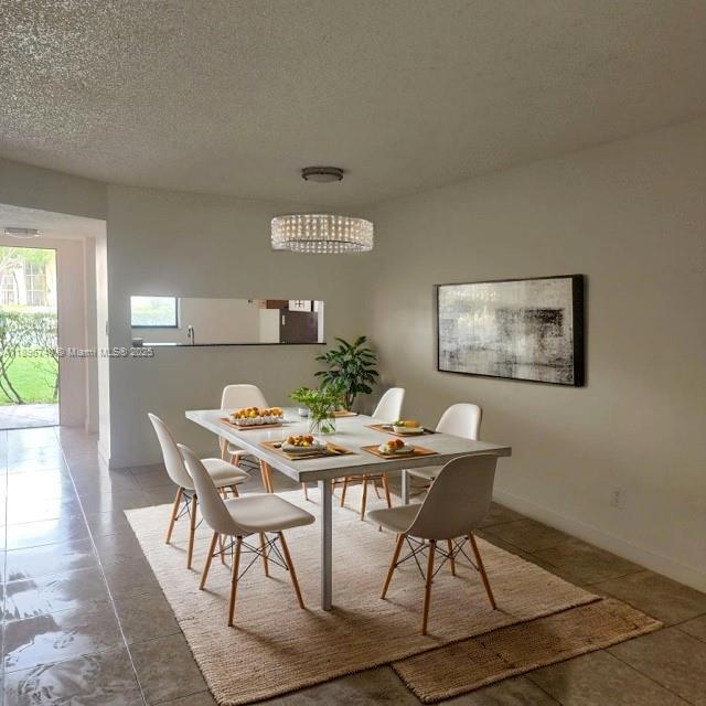 a view of a dining room with furniture and a potted plant