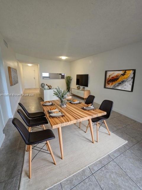 3396 Foxcroft Road, Unit 113 Miramar, FL 33025 - Photo 3 of 10 a living room with furniture a piano and a flat screen tv