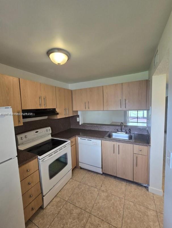 3396 Foxcroft Road, Unit 113 Miramar, FL 33025 - Photo 6 of 10 a kitchen with a stove sink and cabinets