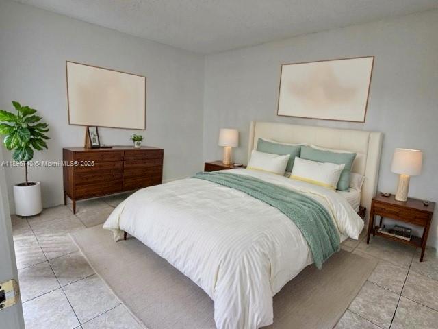 3396 Foxcroft Road, Unit 113 Miramar, FL 33025 - Photo 9 of 10 a bedroom with a bed and a potted plant