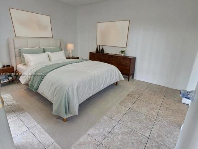 3396 Foxcroft Road, Unit 113 Miramar, FL 33025 - Photo 10 of 10 a bedroom with a bed and a lamp on table