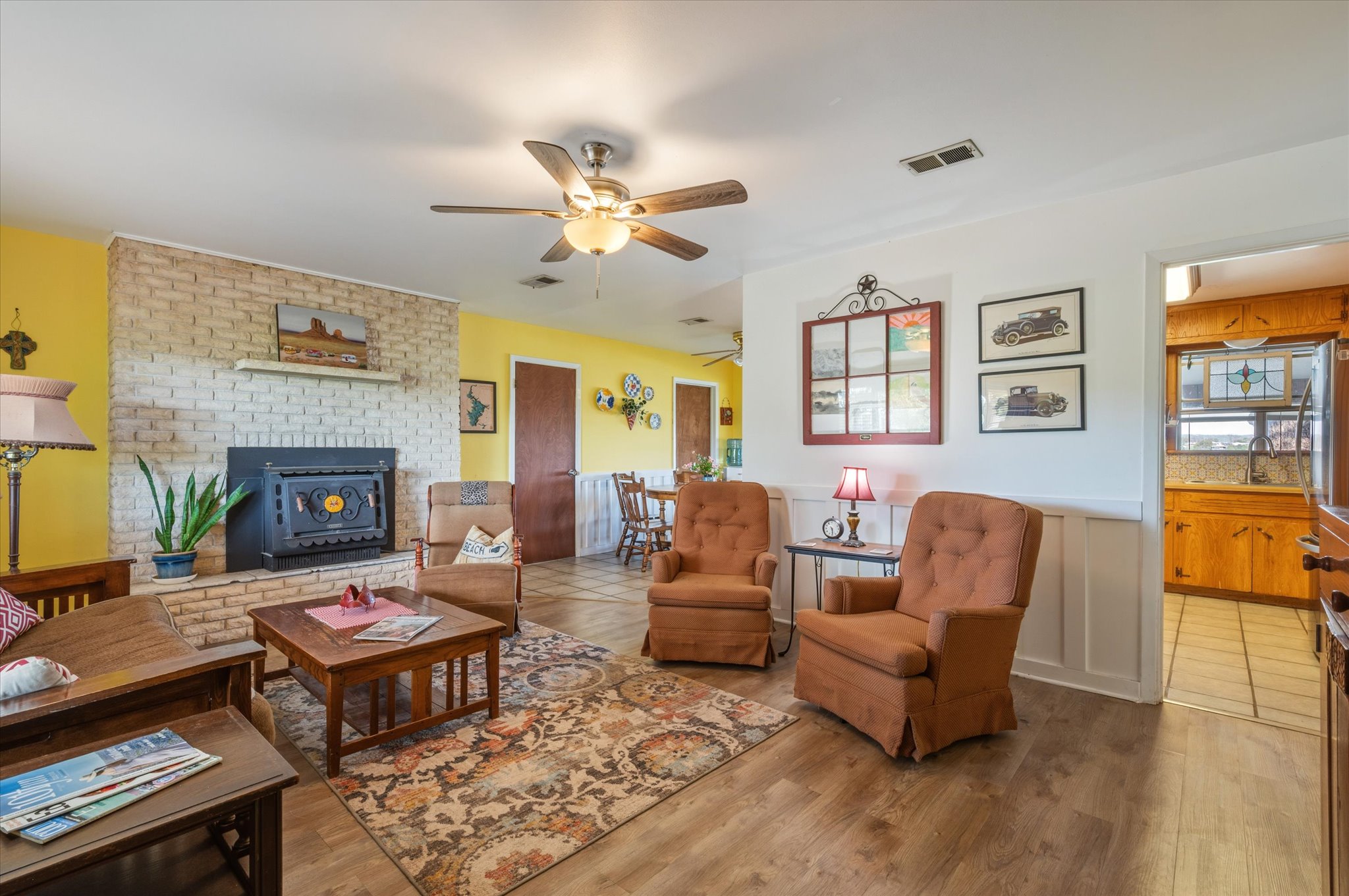210 Lake Loop Tow, TX 78672 - Photo 6 of 28 Living area featuring light wood-style floors, a ceiling fan, and a wainscoted wall