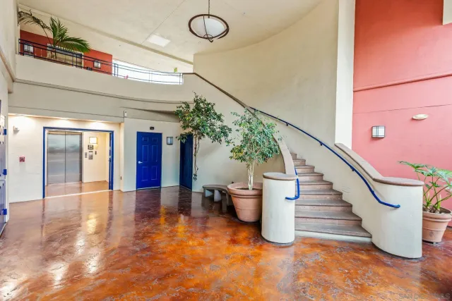 a view of a patio with chairs and potted plants
