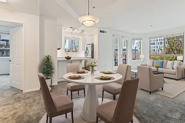 a kitchen with stainless steel appliances granite countertop white cabinets granite counter tops and a window