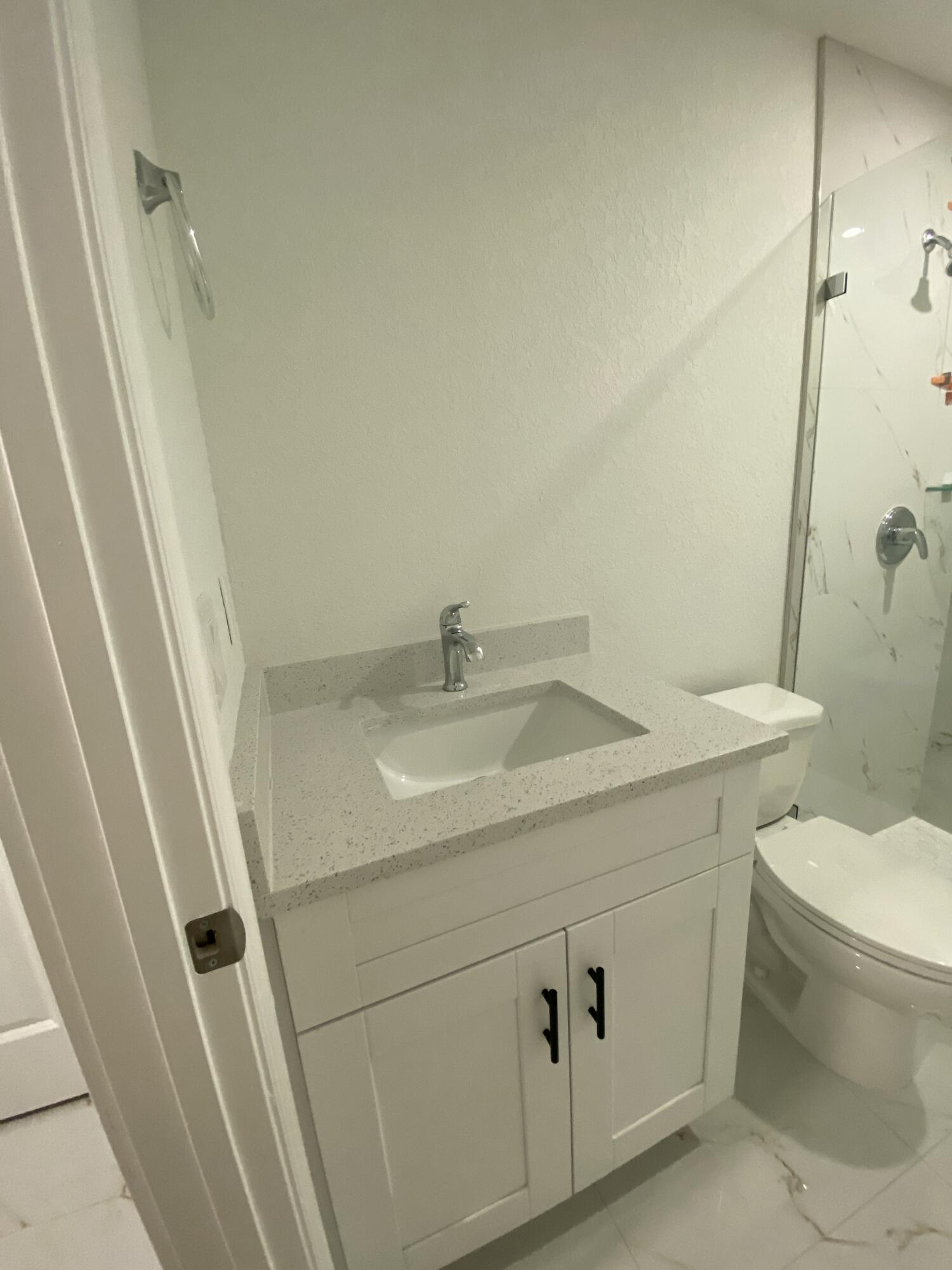 14597 Southwest 170th Avenue Indiantown, FL 34956 - Photo 23 of 31 a bathroom with a sink a toilet and a shower