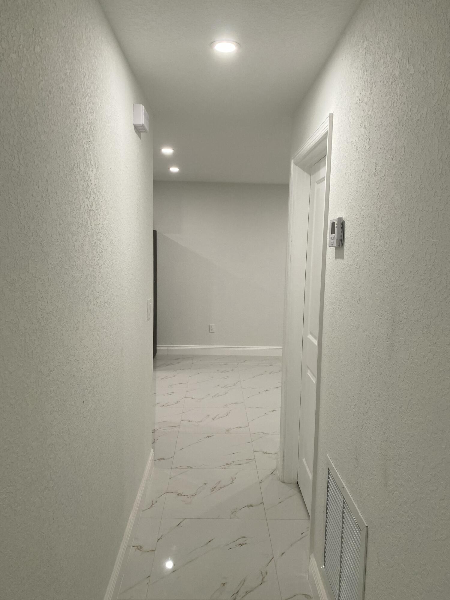 14597 Southwest 170th Avenue Indiantown, FL 34956 - Photo 26 of 31 a view of hallway with shower