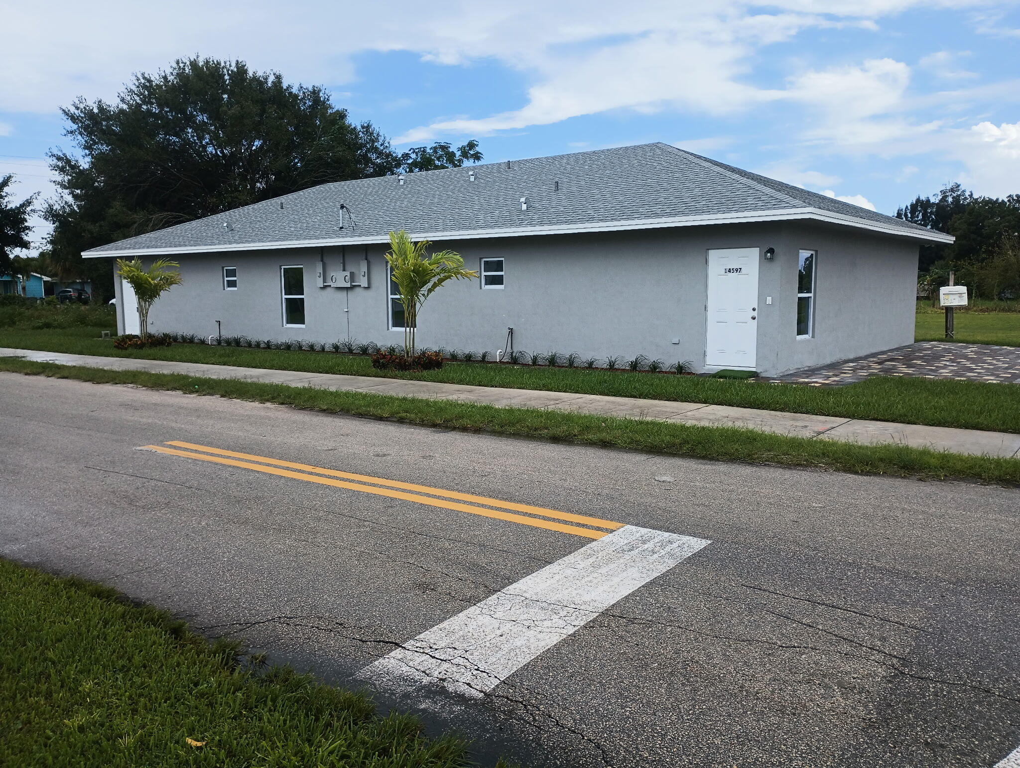 14597 Southwest 170th Avenue Indiantown, FL 34956 - Photo 4 of 31 a front view of a house with a yard and garage