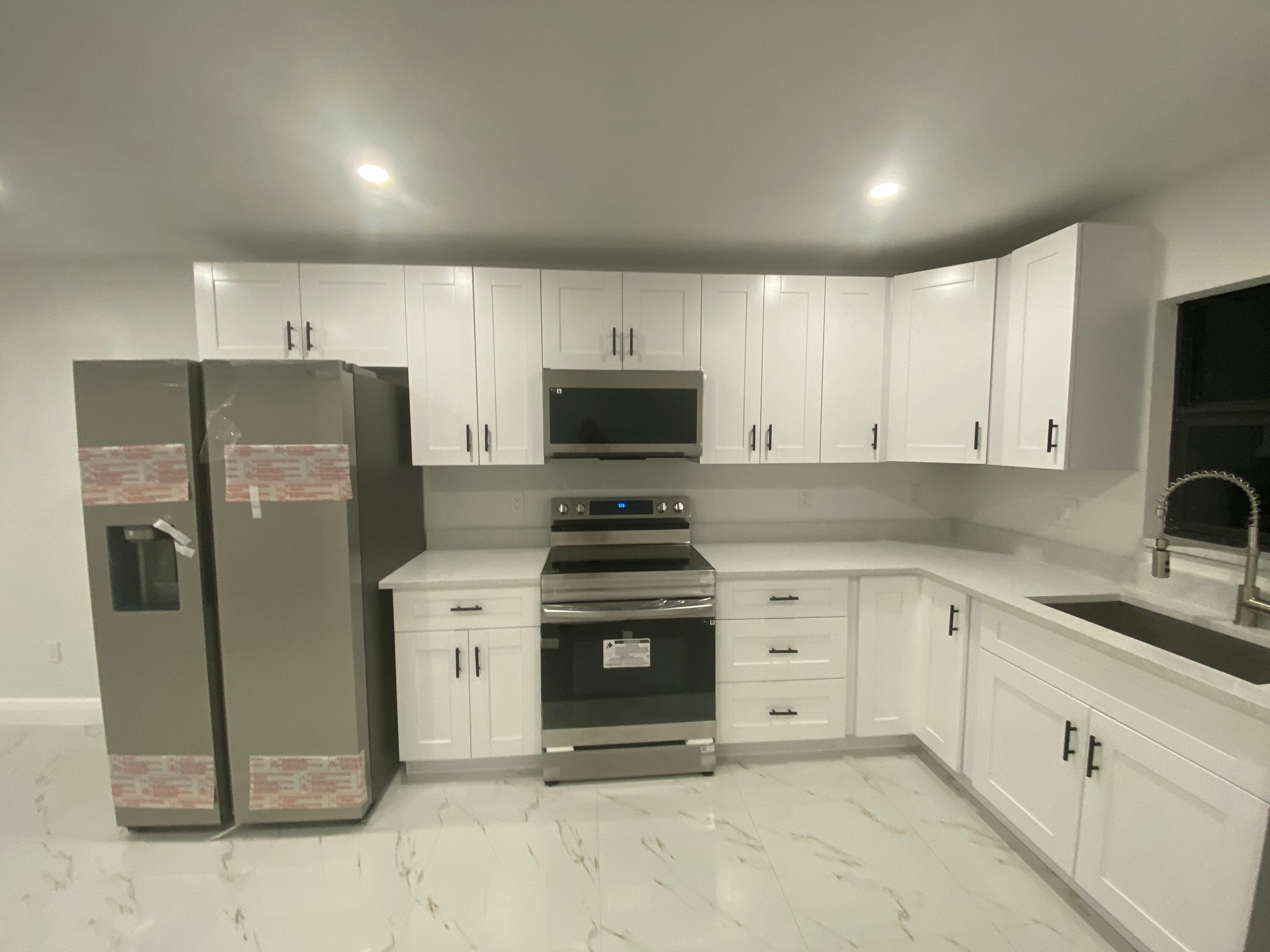 14597 Southwest 170th Avenue Indiantown, FL 34956 - Photo 10 of 31 a kitchen with stainless steel appliances granite countertop a stove a refrigerator and a sink