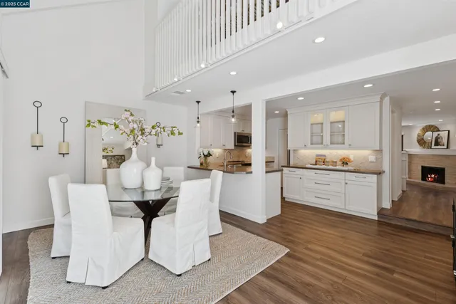 a living room with furniture and kitchen view