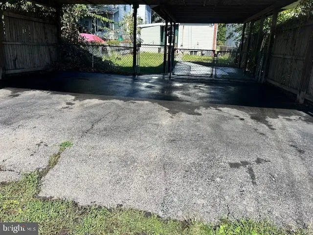 a view of street with wooden fence